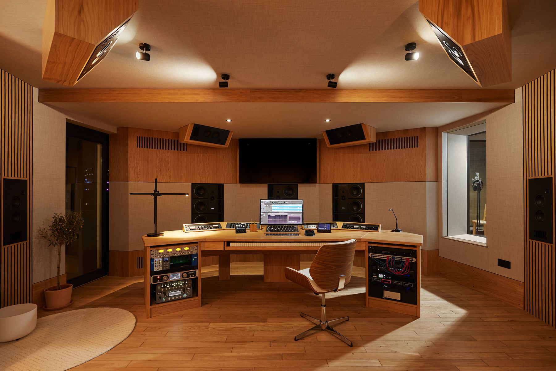 Control room with immersive speaker array and oak mixing desk