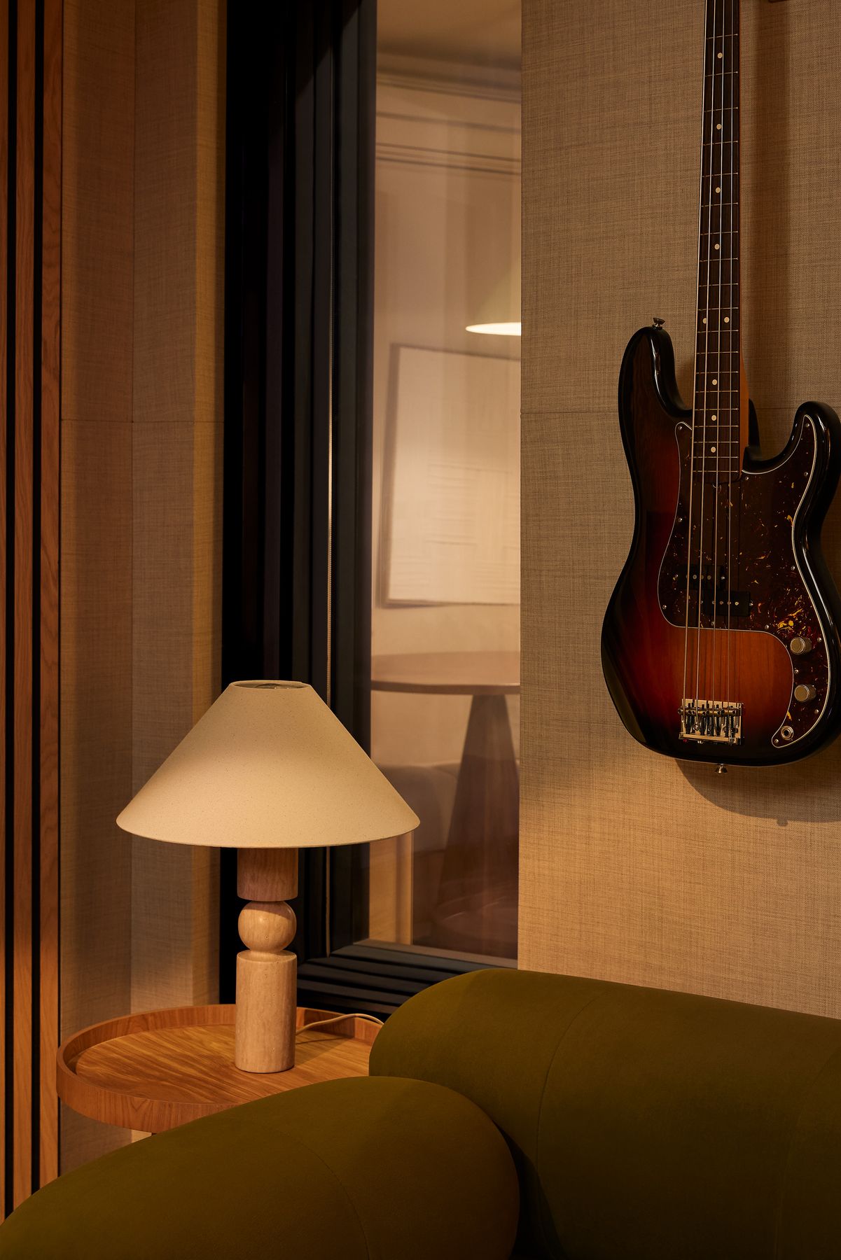 Travertine lamp beside a sunburst bass